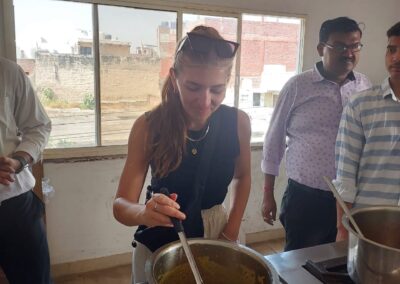 a woman cooking food in a kitchen