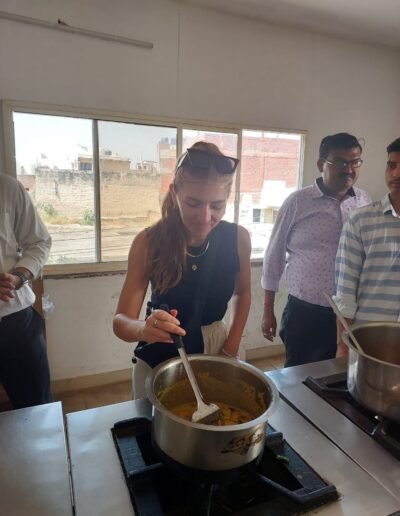 a woman cooking food in a kitchen