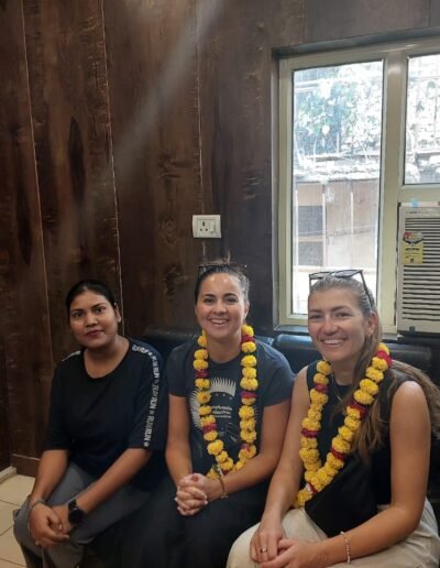 a group of people standing around a table with food